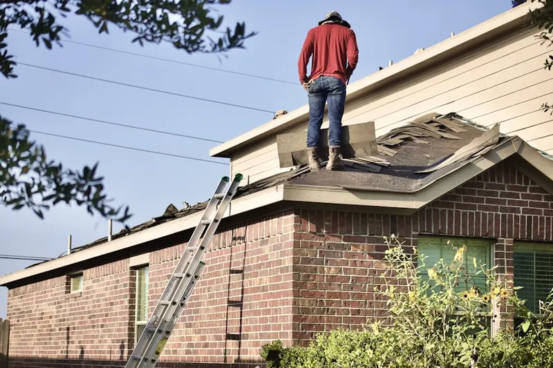 Professional roofer working on a residential roof in Purity